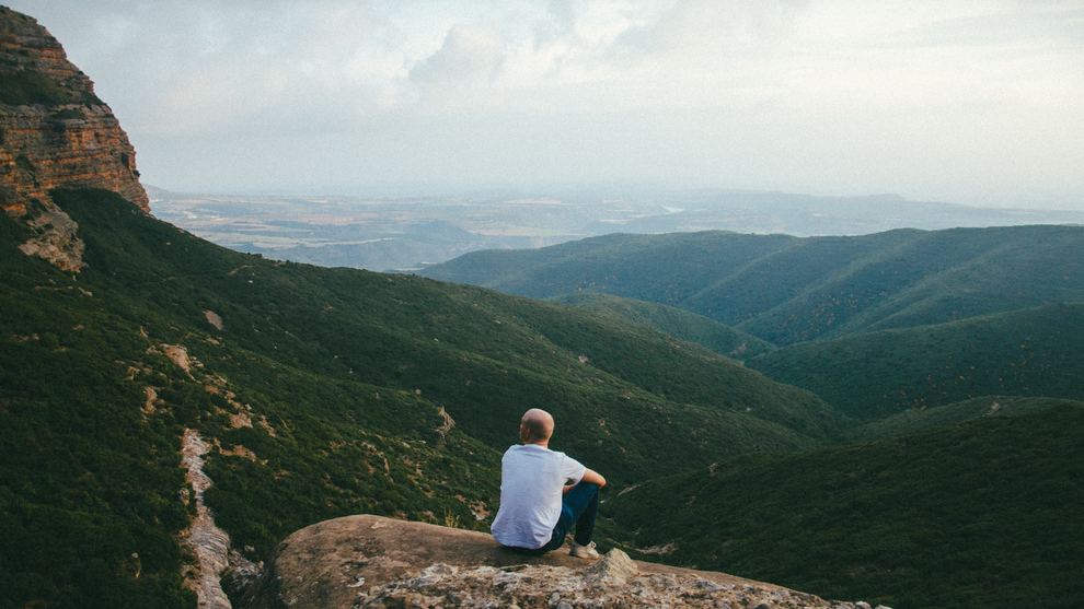 Man Sitting in Mountains