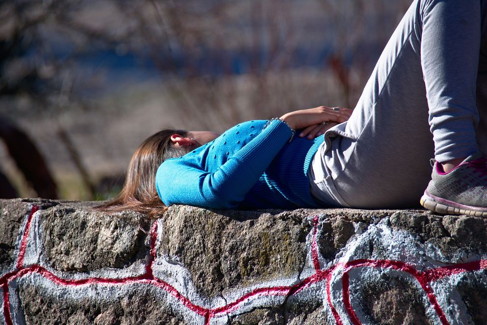 Woman Lying on Stone Wall