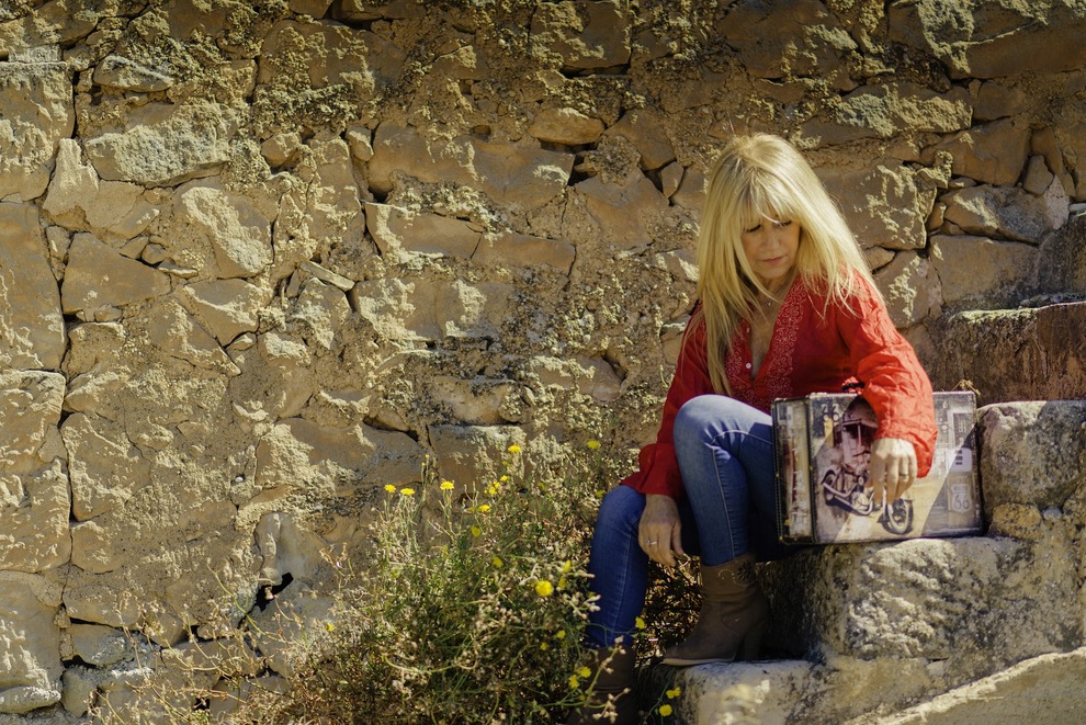 Woman with Suitcase on Stone Steps