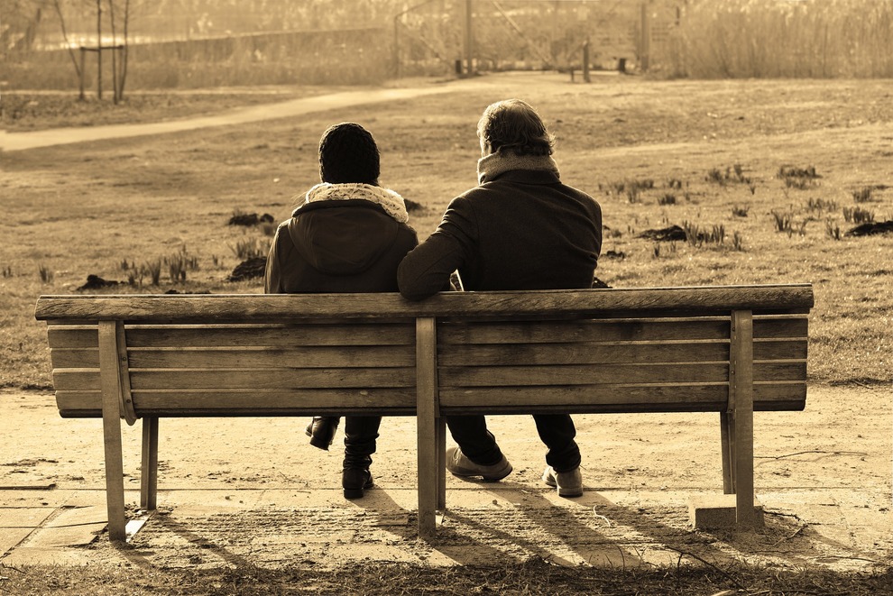 Two people at bench from behind