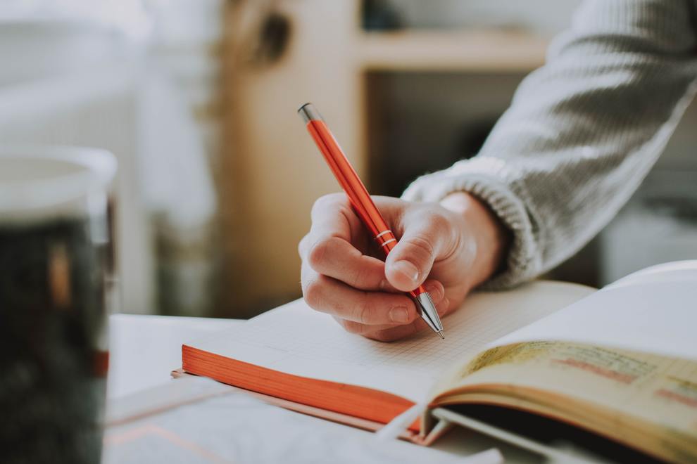 Writing in Journal with Red Pen