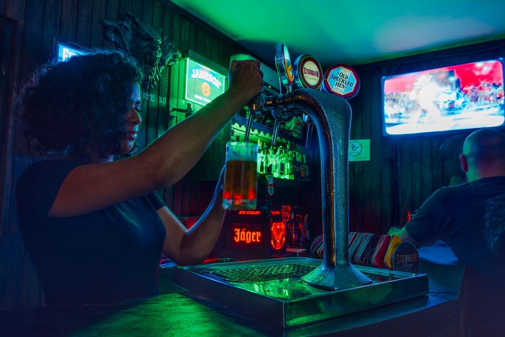 Woman Pouring a Beer at Bar