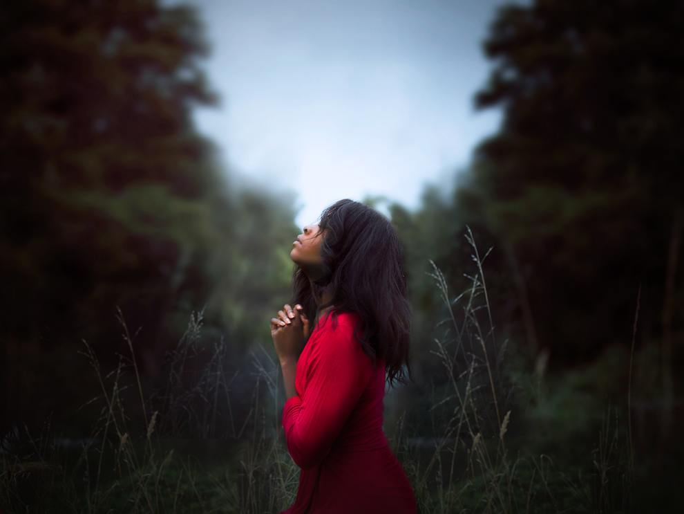 black woman praying profile