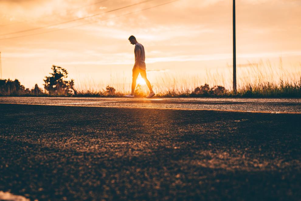 man walking in sunset