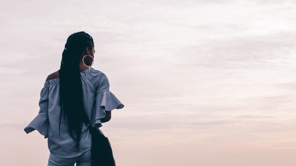 African American woman looking at evening sky