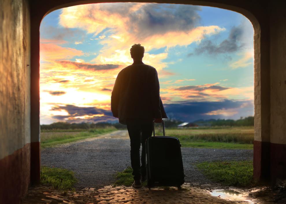 man with suitcase heading into horizon