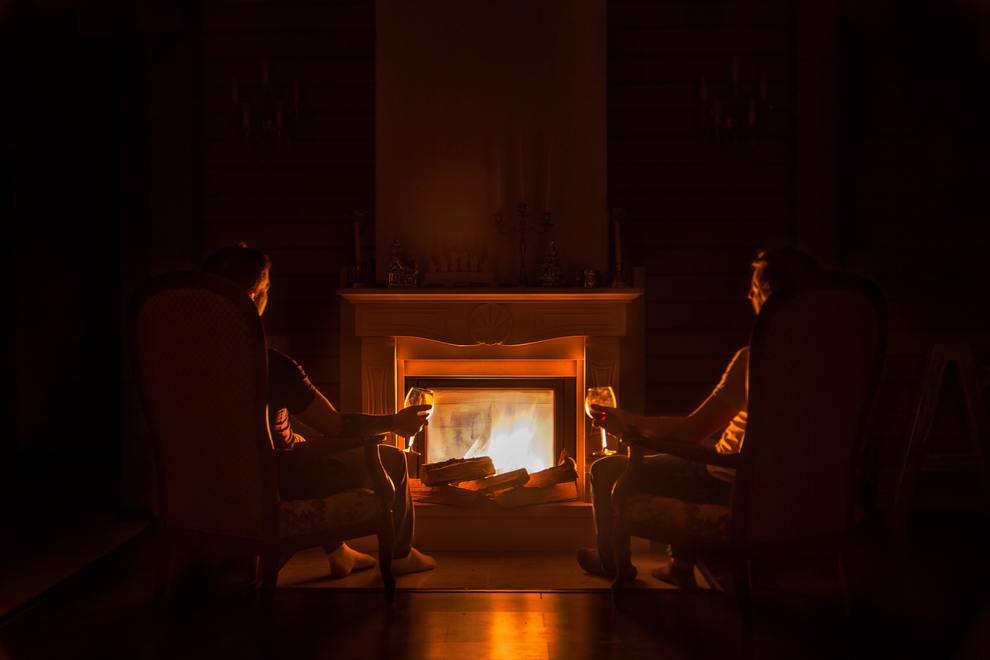 two people drinking by fire