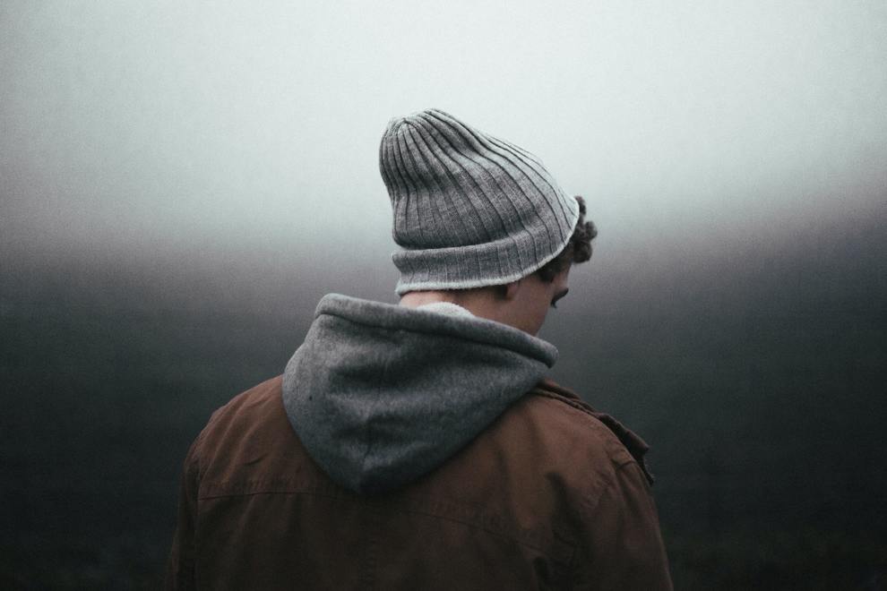 young man beanie turning away