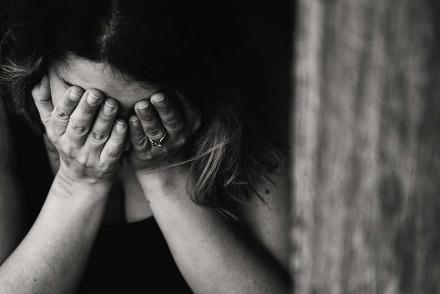 woman with hands covering face