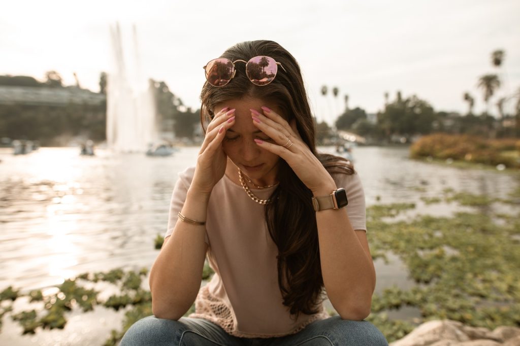 woman with hands to her head