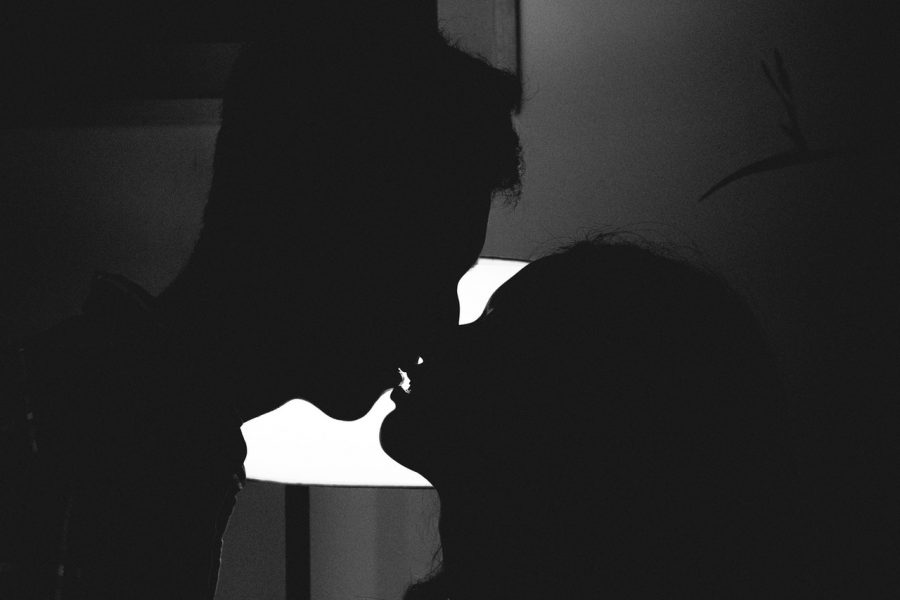 man and woman kissing