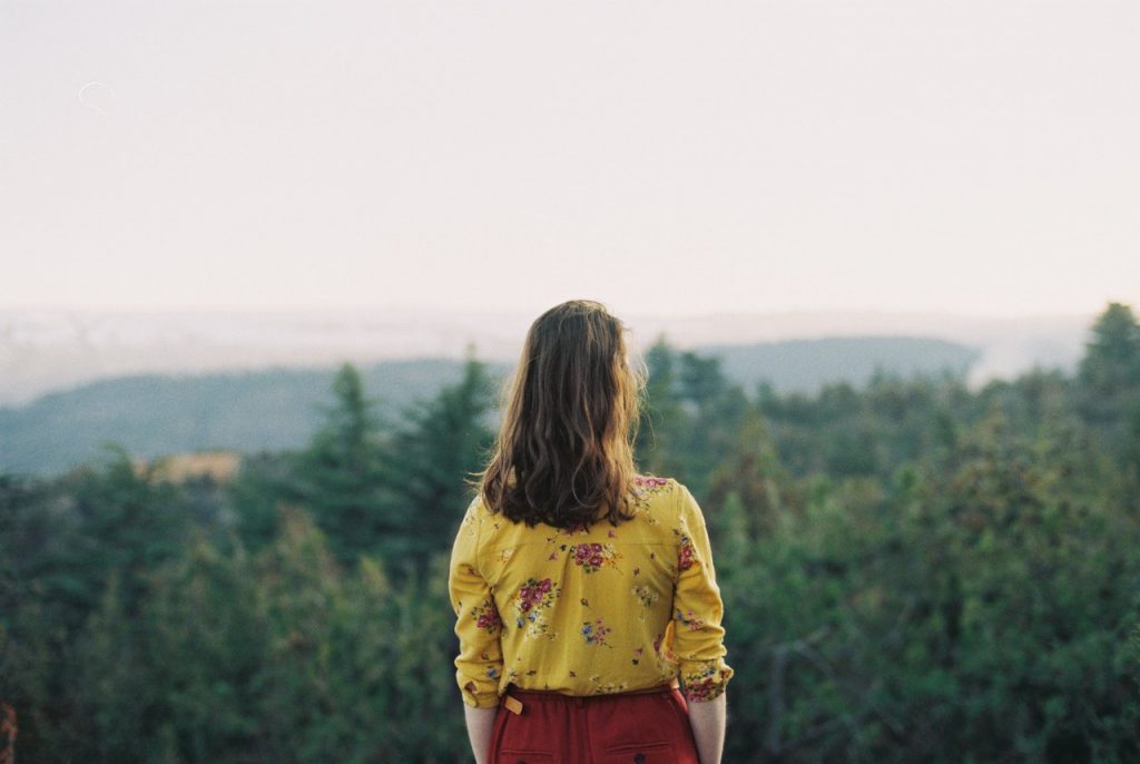 woman looking at woods