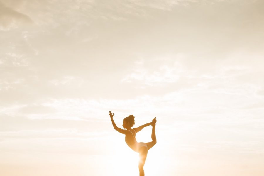 woman stretching in sunlight