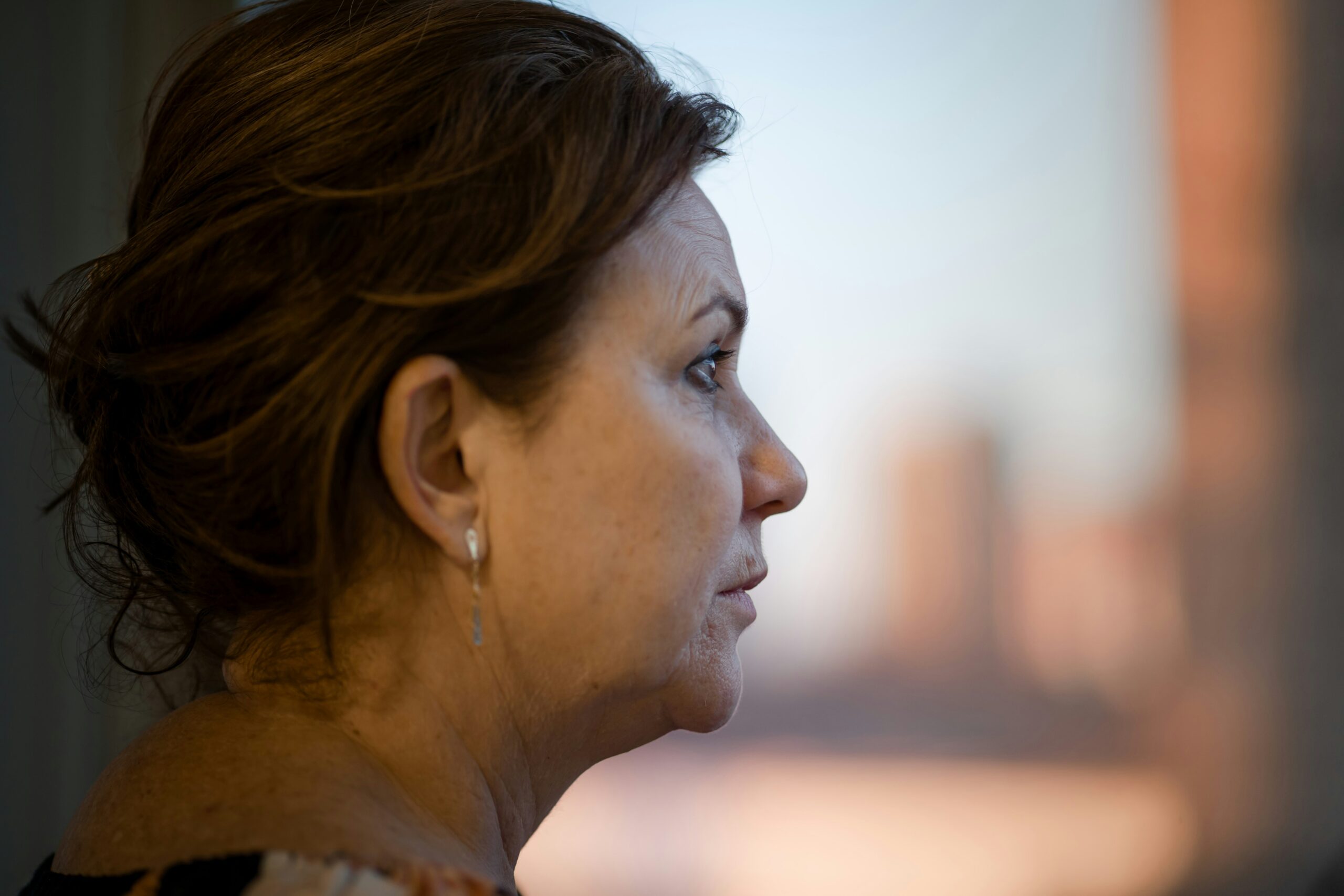 woman at window worried pensive